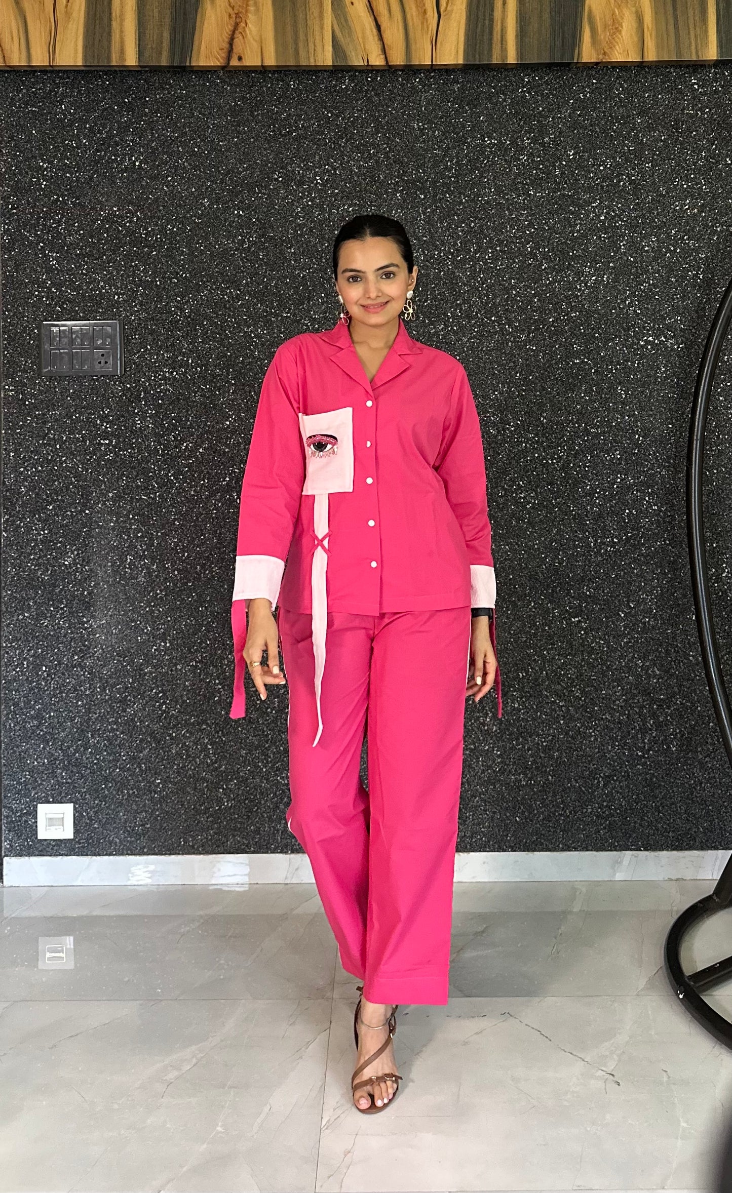 Person wearing a pink outfit with a black background