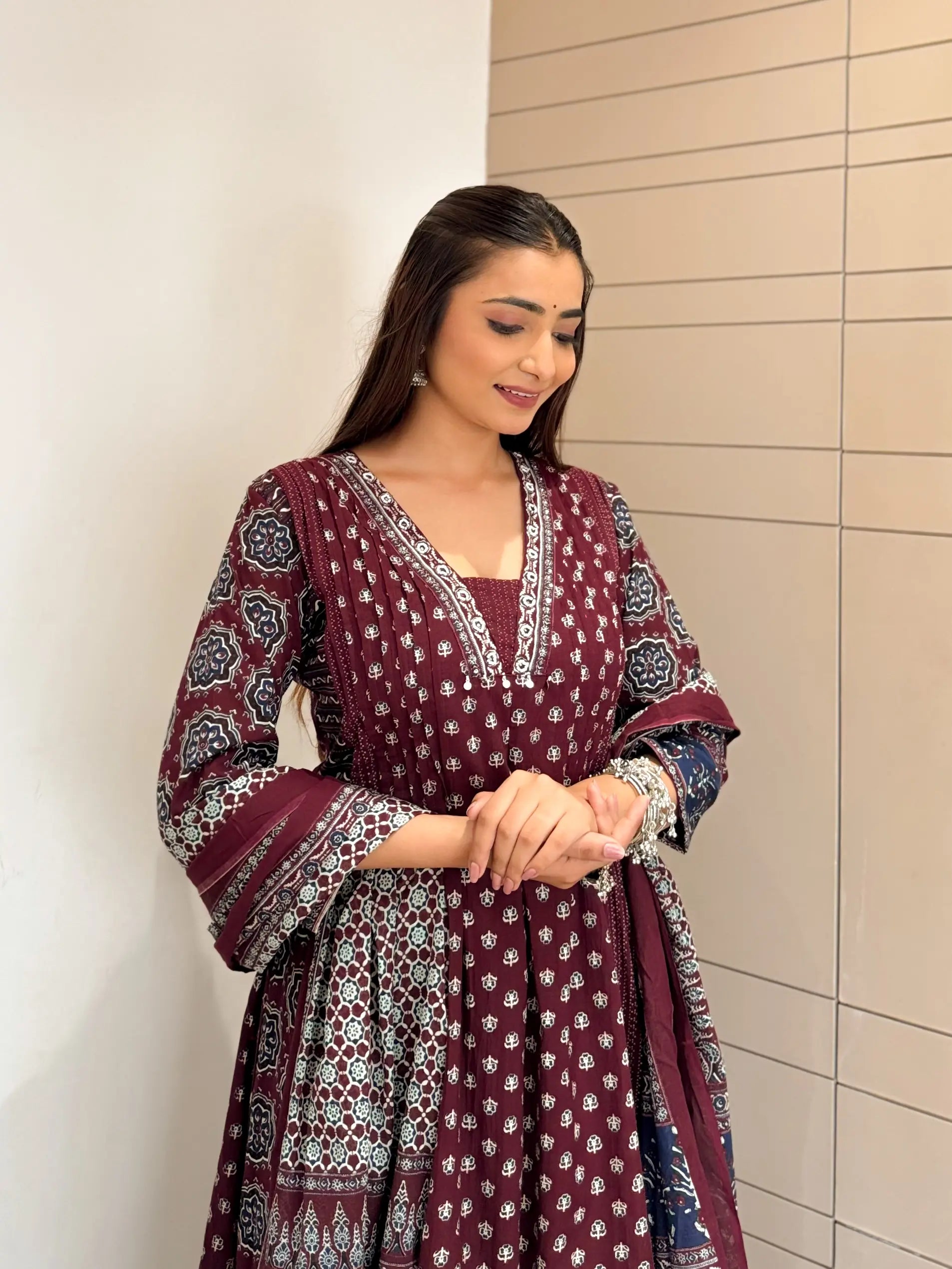 Elegant V-neck kurta featuring traditional ethnic prints and detailed border design.