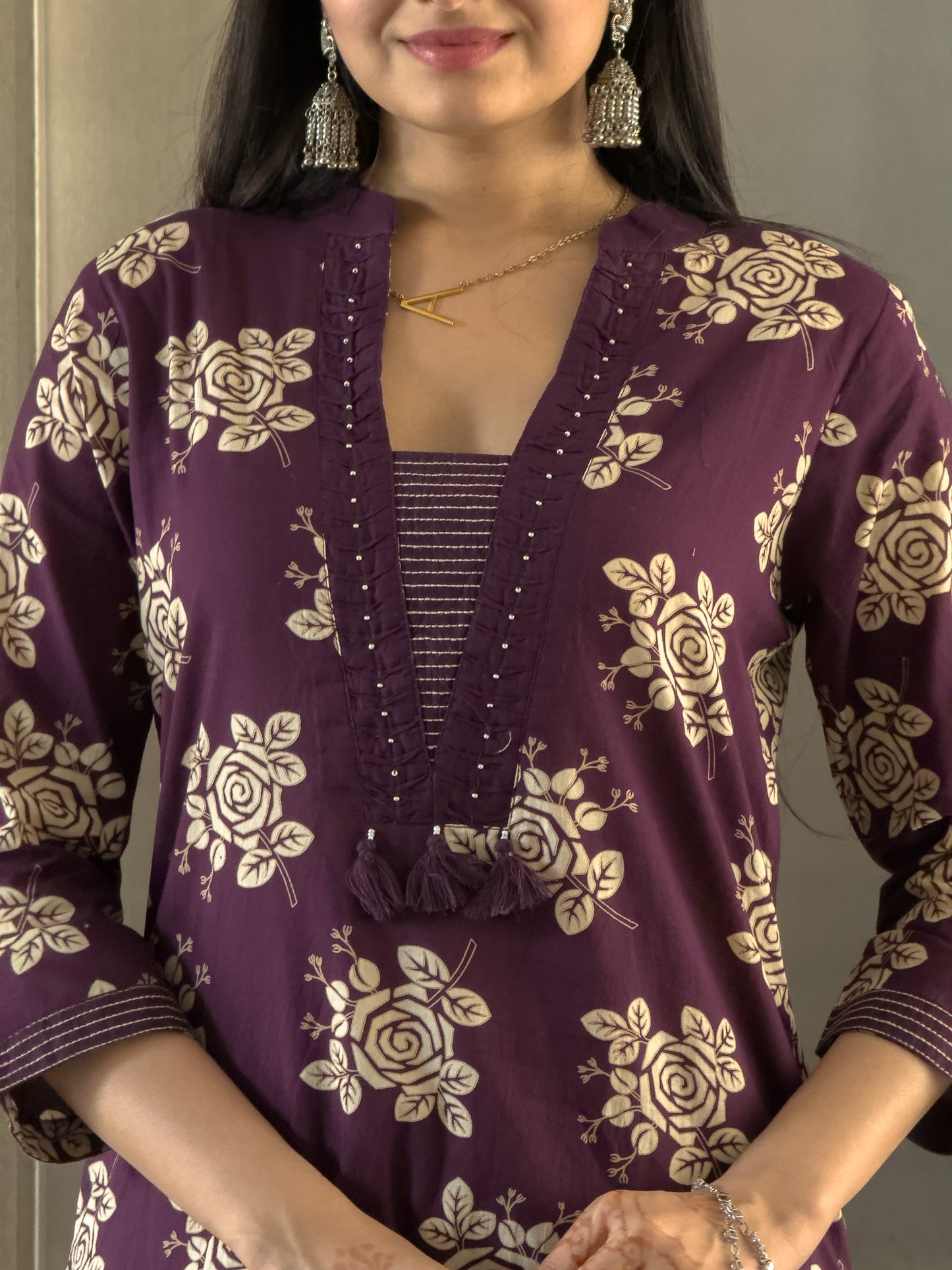 Woman wearing a purple floral patterned top .