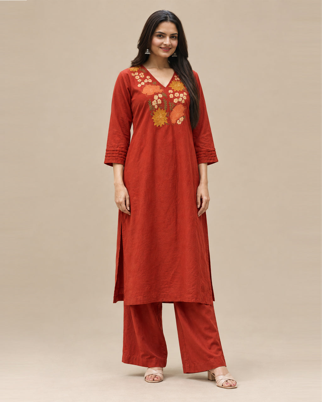 Elegant rust A-line kurta with floral embroidery, bell sleeves, and matching palazzo pants.