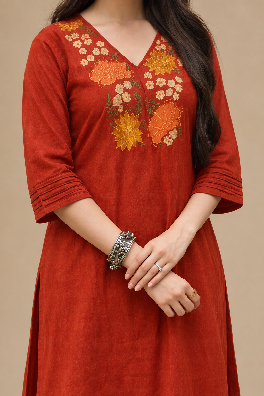Women’s rust floral embroidered kurta paired with matching palazzo pants and bell sleeves.