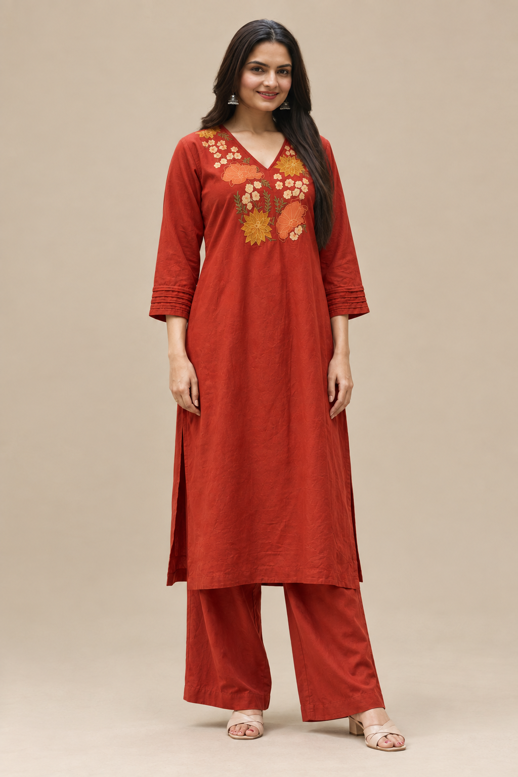 Women’s rust ethnic kurta set featuring floral embroidery, bell sleeves, and matching palazzo pants.