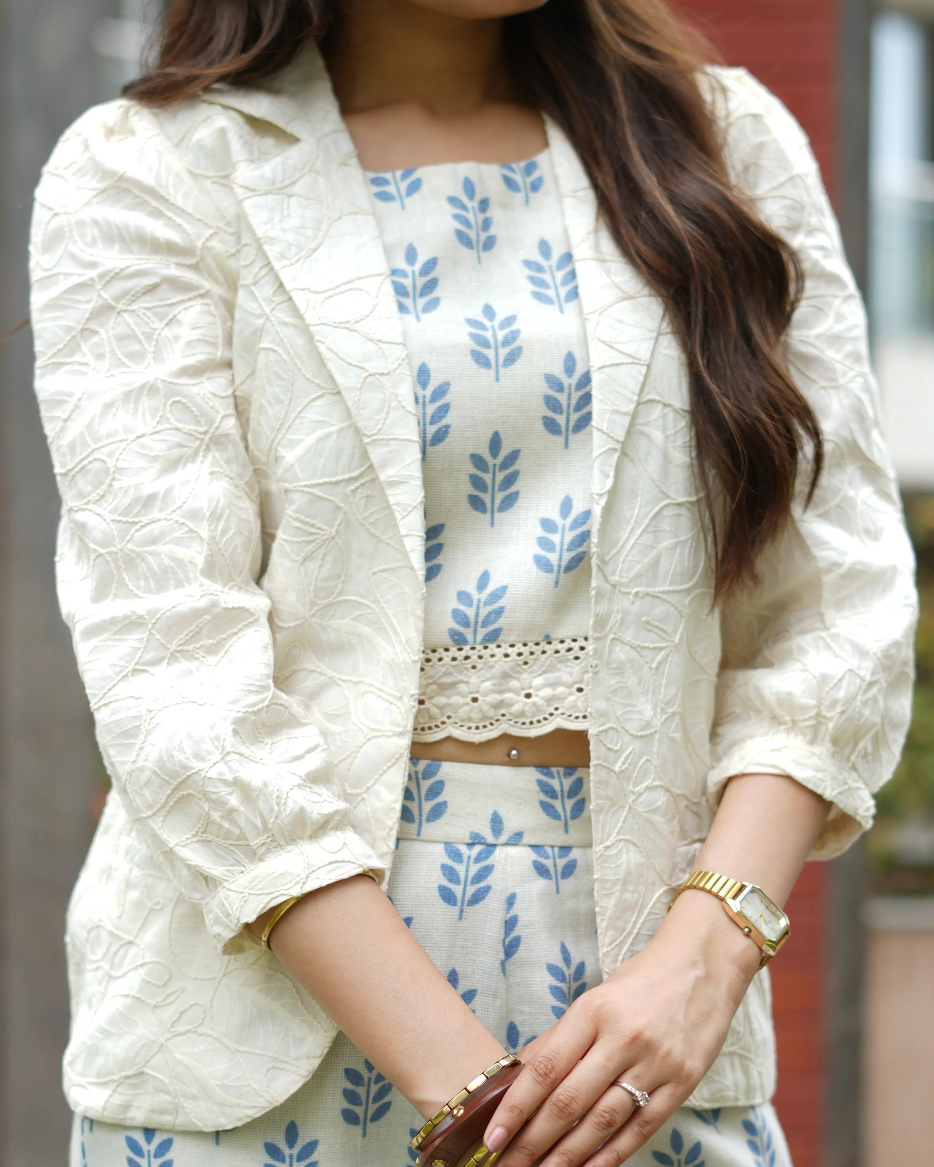 Elegant sleeveless crop top paired with straight-fit printed pants and a stylish blazer.